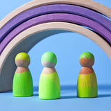 Set of 3 Grimms handcrafted wooden peg dolls painted in bright green standing under rainbow arches