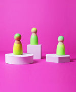 Set of 3 Grimms handcrafted wooden peg dolls painted in bright green. Perfect for open ended play and story sacks