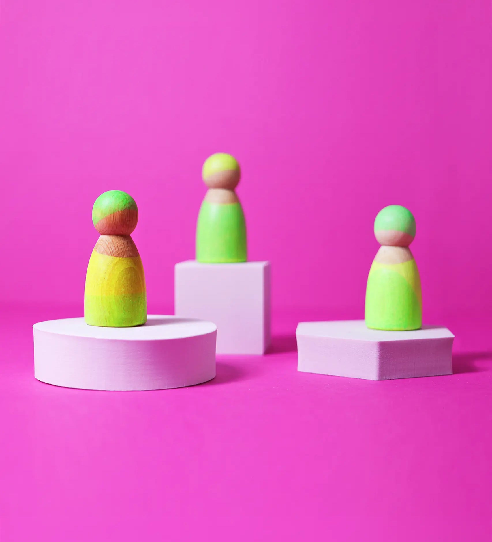 Set of 3 Grimms handcrafted wooden peg dolls painted in bright green. Perfect for open ended play and story sacks