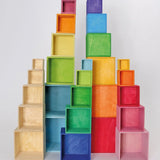Natural, rainbow and pastel Grimm's large wooden build boxes stacked