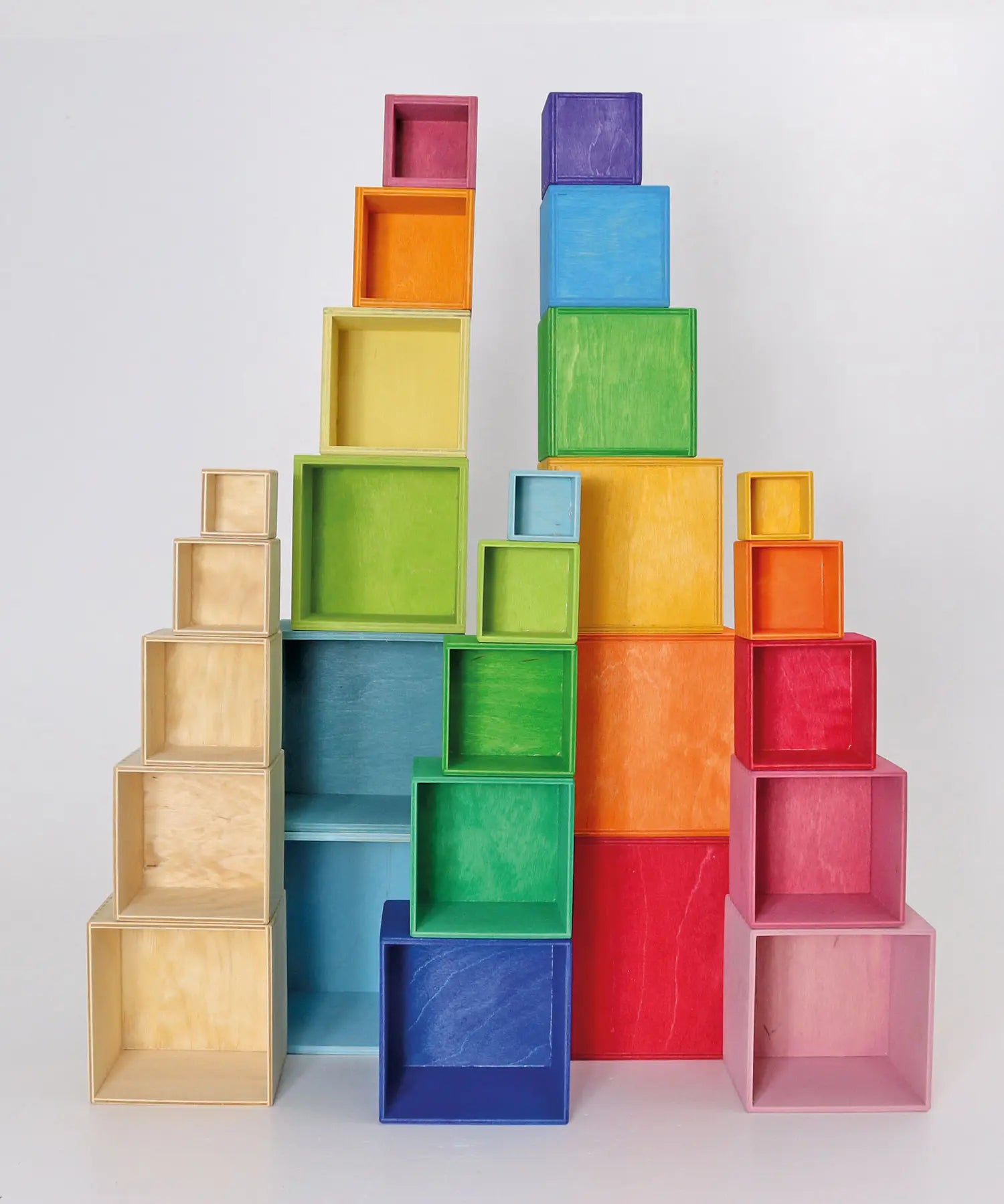 Natural, rainbow and pastel Grimm's large wooden build boxes stacked