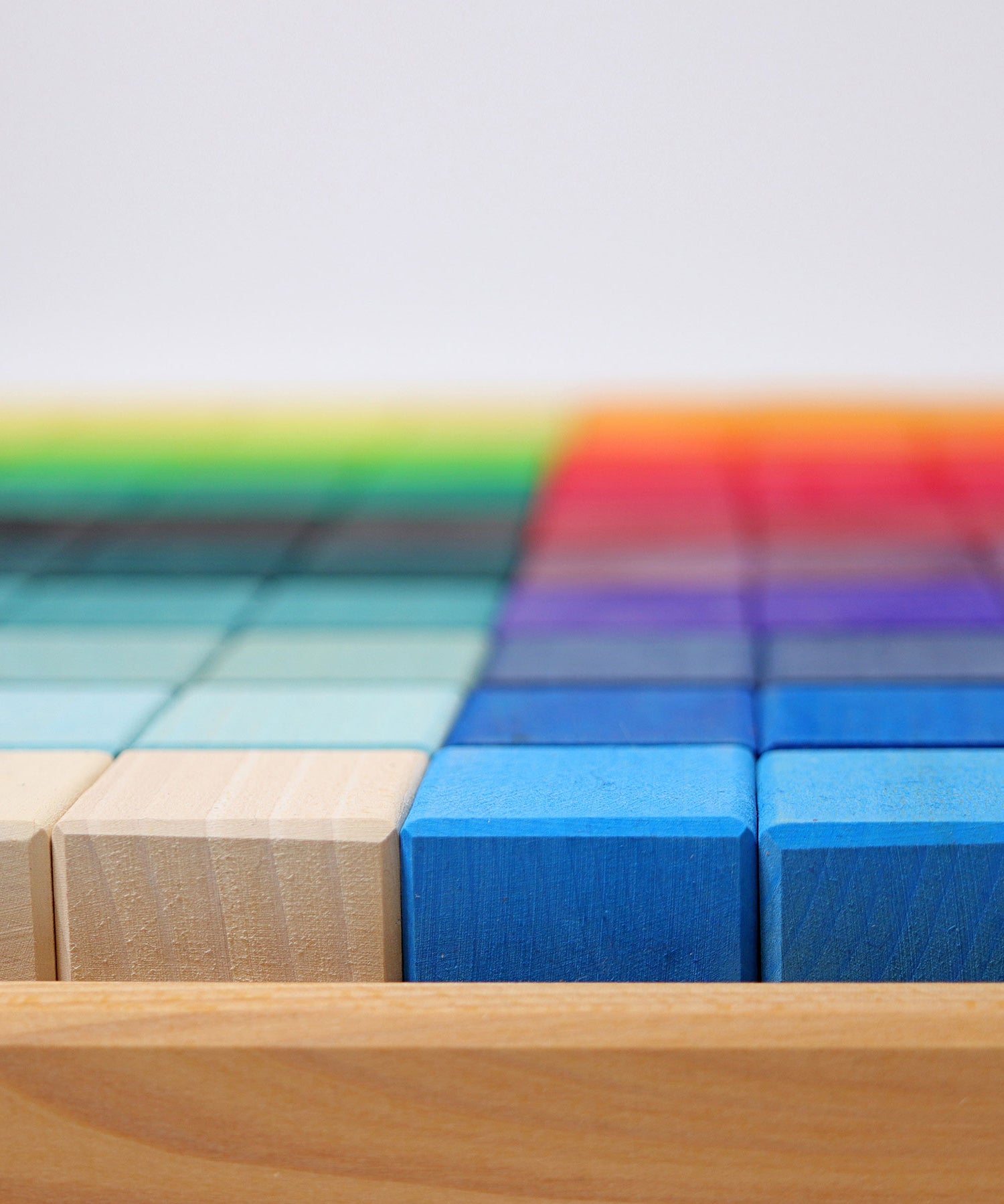 A close up of the side of the Grimm's Large Mosaic Square with the block in the wooden tray. 