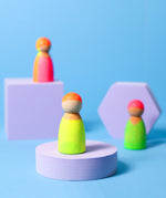 Grimms wooden friends in a hand painted neon mix finish standing on 3 wooden purple platforms