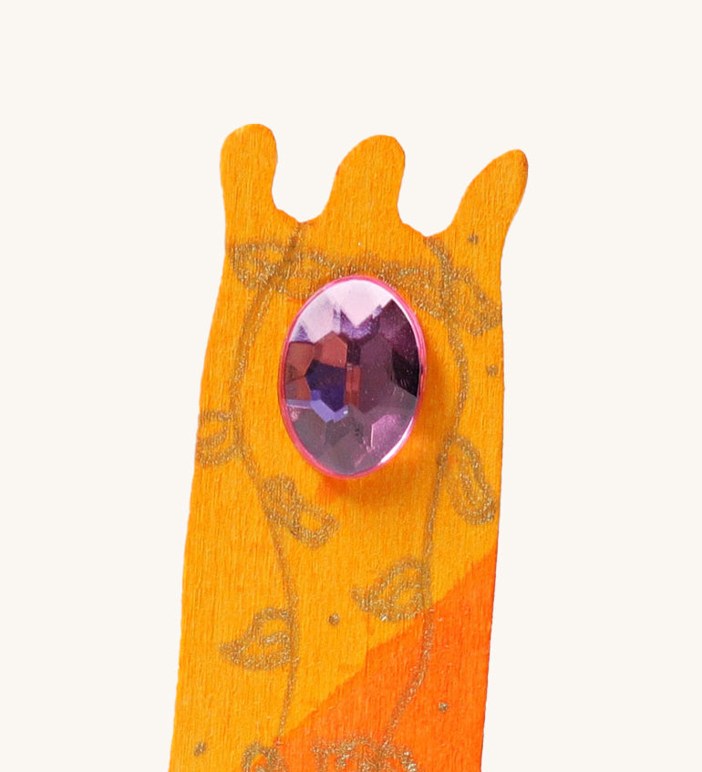 A close up of the orange tower decorative figure showing the purple gem and hand painted leaves detail