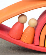 Grimms handcrafted wooden rainbow bridges showing close up detail of 2 peg dolls in between arched pieces