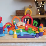 A display using Grimms handcrafted wooden rainbow bridges, houses, peg dolls and balls