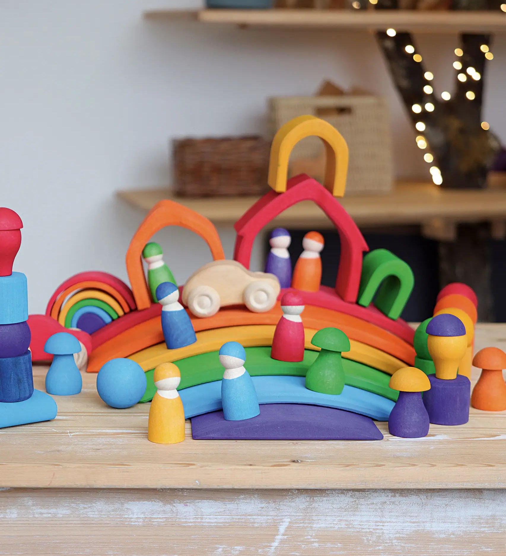A display using Grimms handcrafted wooden rainbow bridges, houses, peg dolls and balls