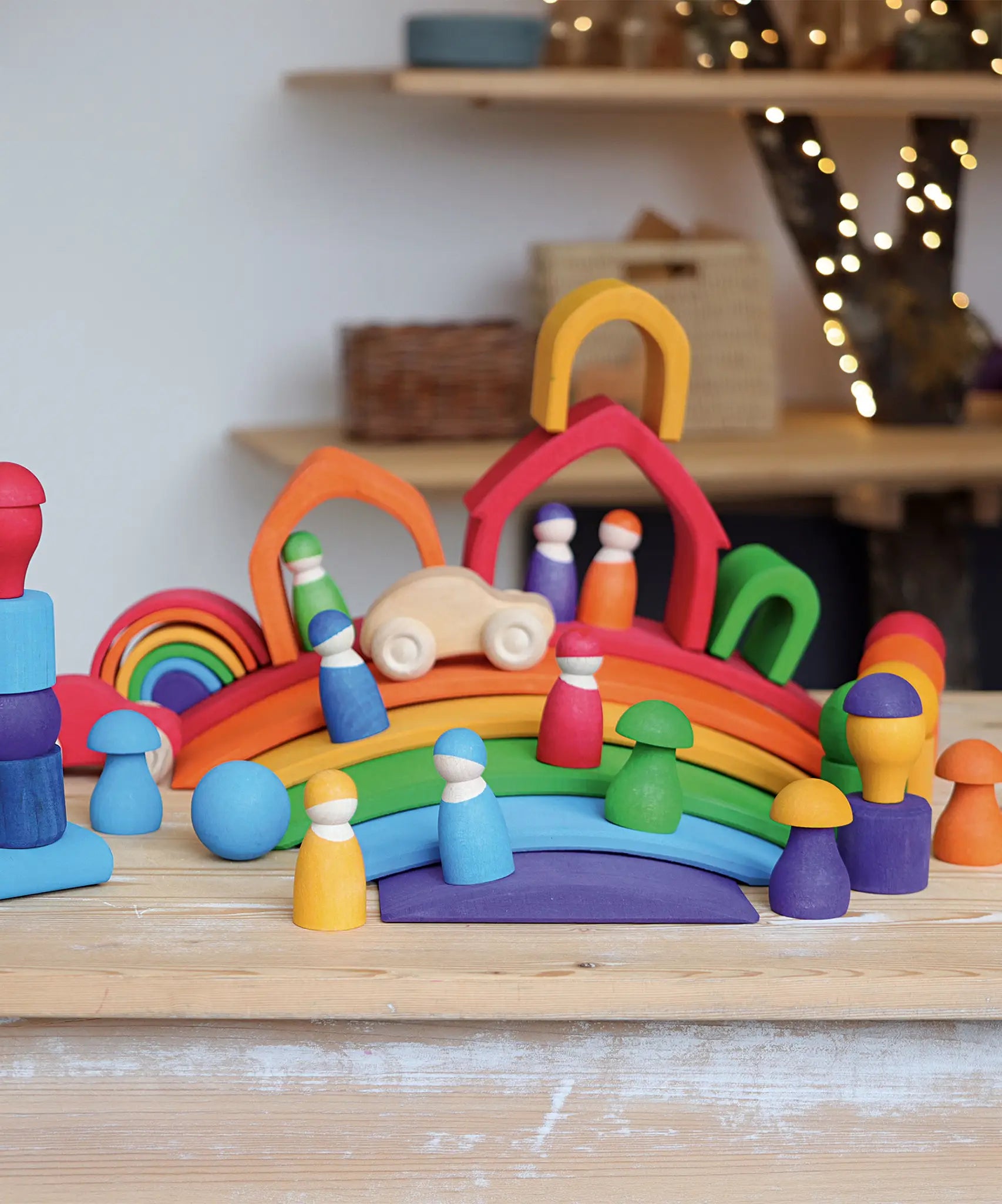 A display using Grimms handcrafted wooden rainbow bridges, houses, peg dolls and balls