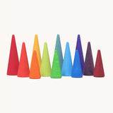 A set of tall and short Grimms wooden forest pieces in a rainbow palette. Made  for open ended play and learning