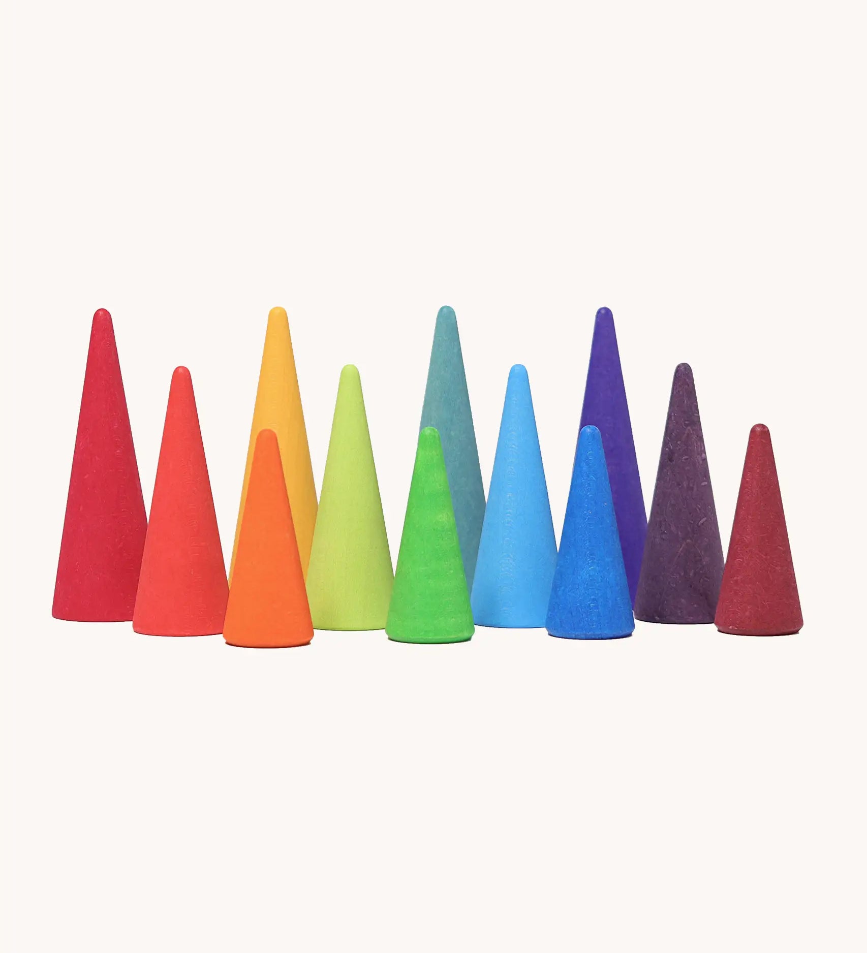 A set of tall and short Grimms wooden forest pieces in a rainbow palette. Made  for open ended play and learning