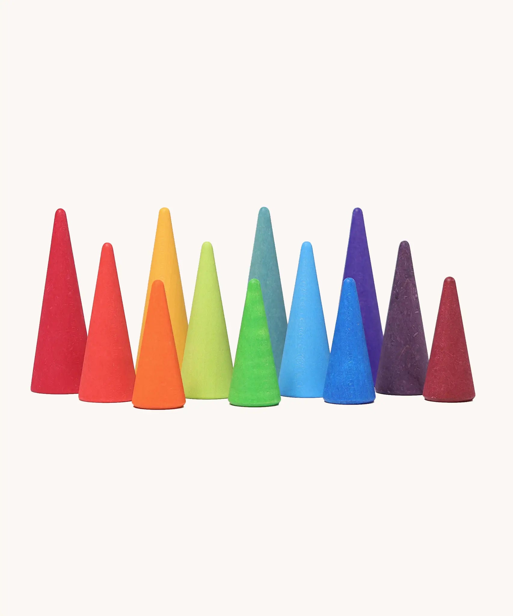 A set of tall and short Grimms wooden forest pieces in a rainbow palette. Made  for open ended play and learning