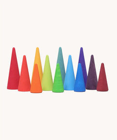 A set of tall and short Grimms wooden forest pieces in a rainbow palette. Made  for open ended play and learning