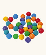 Set of 35 Grimms handcrafted wooden 2cm marbles in a rainbow palette. 