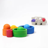 Grimms brightly coloured wooden sorting bowls with balls sitting in each bowl