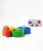 Grimms brightly coloured wooden sorting bowls with balls sitting in each bowl