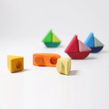 Loose Grimms handcrafted wooden rolling boat pieces showing the cut out  slots and dowels