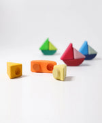 Loose Grimms handcrafted wooden rolling boat pieces showing the cut out  slots and dowels