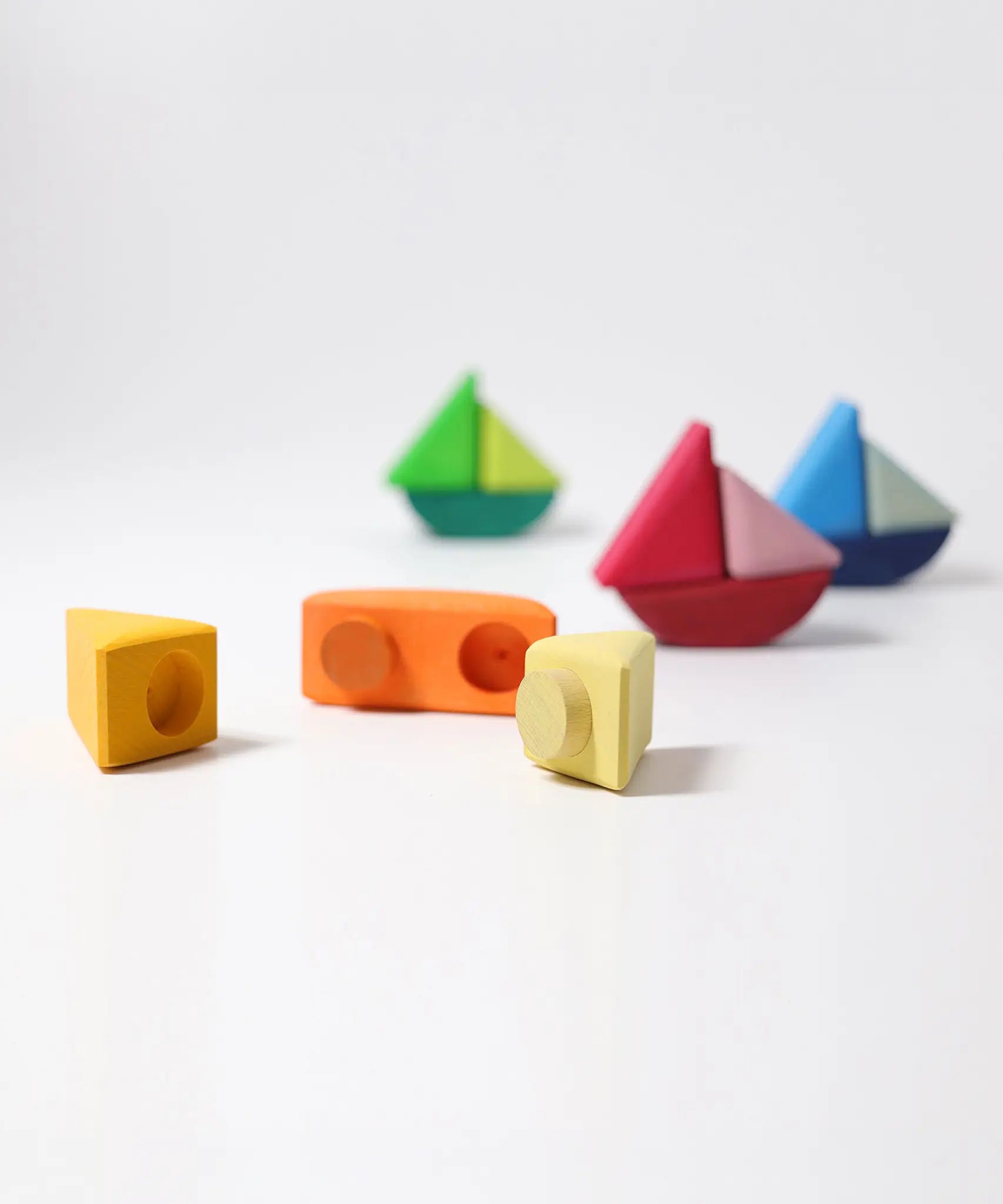 Loose Grimms handcrafted wooden rolling boat pieces showing the cut out  slots and dowels