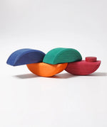 Half sphere pieces the Grimms wooden rolling boats set joined together by the dowels