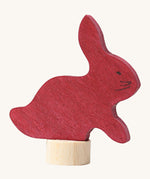 Grimms wooden sitting rabbit decorative figure in dark red. Features a small base stand to slot in the celebration ring
