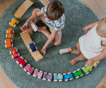Children playing with the Grimm's Stacking Cars. Wooden toy cars that comes in a two back that can can be stacked on top of each other.
These Grimm's toys are part of a wide range of wooden toys available here at Babipur. 