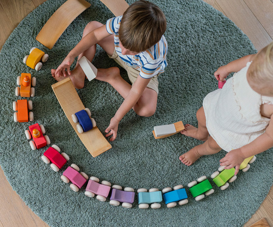 Children playing with the Grimm's Stacking Cars. Wooden toy cars that comes in a two back that can can be stacked on top of each other.
These Grimm's toys are part of a wide range of wooden toys available here at Babipur. 