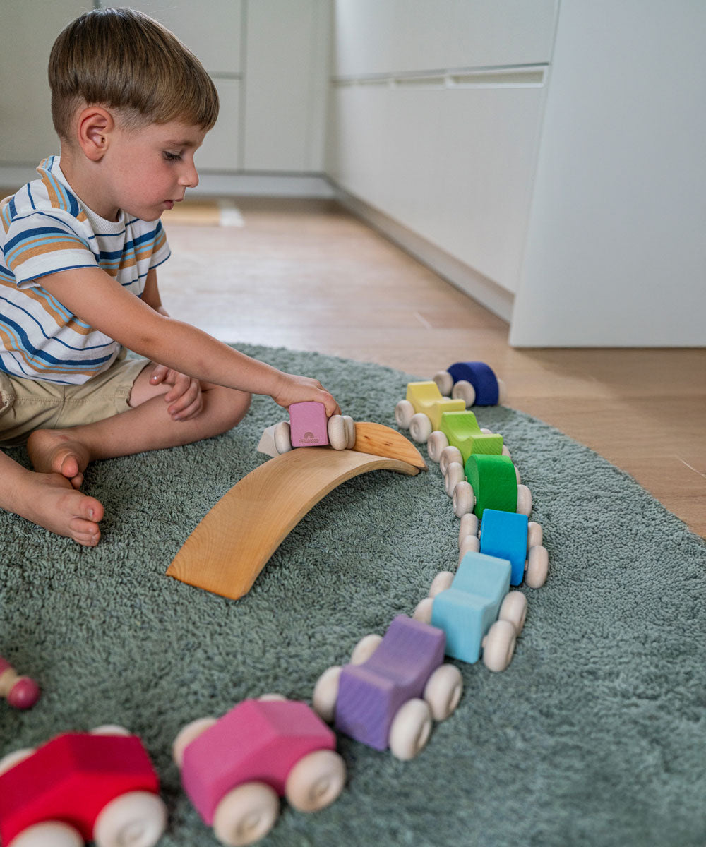 A child playing with the Grimm's Stacking Cars. Wooden toy cars that comes in a two back that can can be stacked on top of each other.
These Grimm's toys are part of a wide range of wooden toys available here at Babipur. 