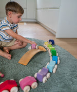 A child playing with the Grimm's Stacking Cars. Wooden toy cars that comes in a two back that can can be stacked on top of each other.
These Grimm's toys are part of a wide range of wooden toys available here at Babipur. 