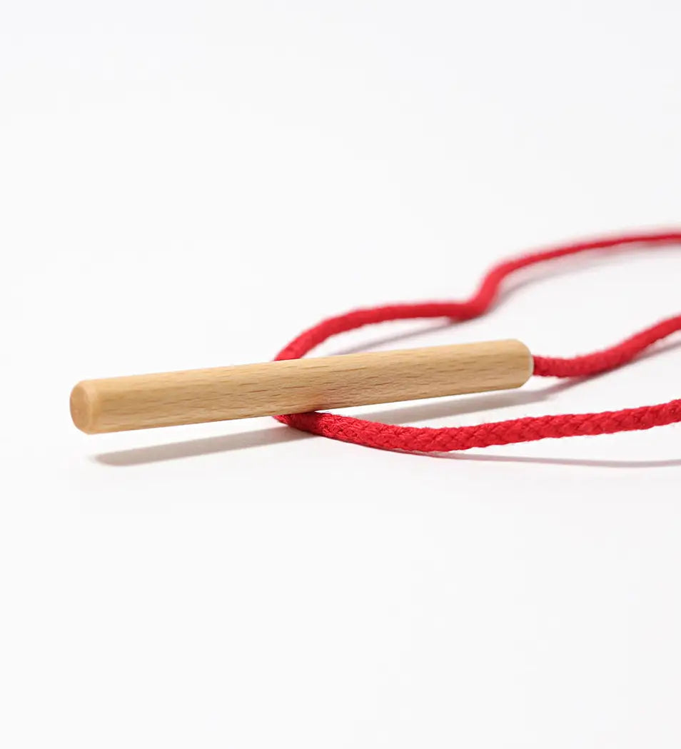 Grimms wooden threading needle showing needle detail with red cord attached