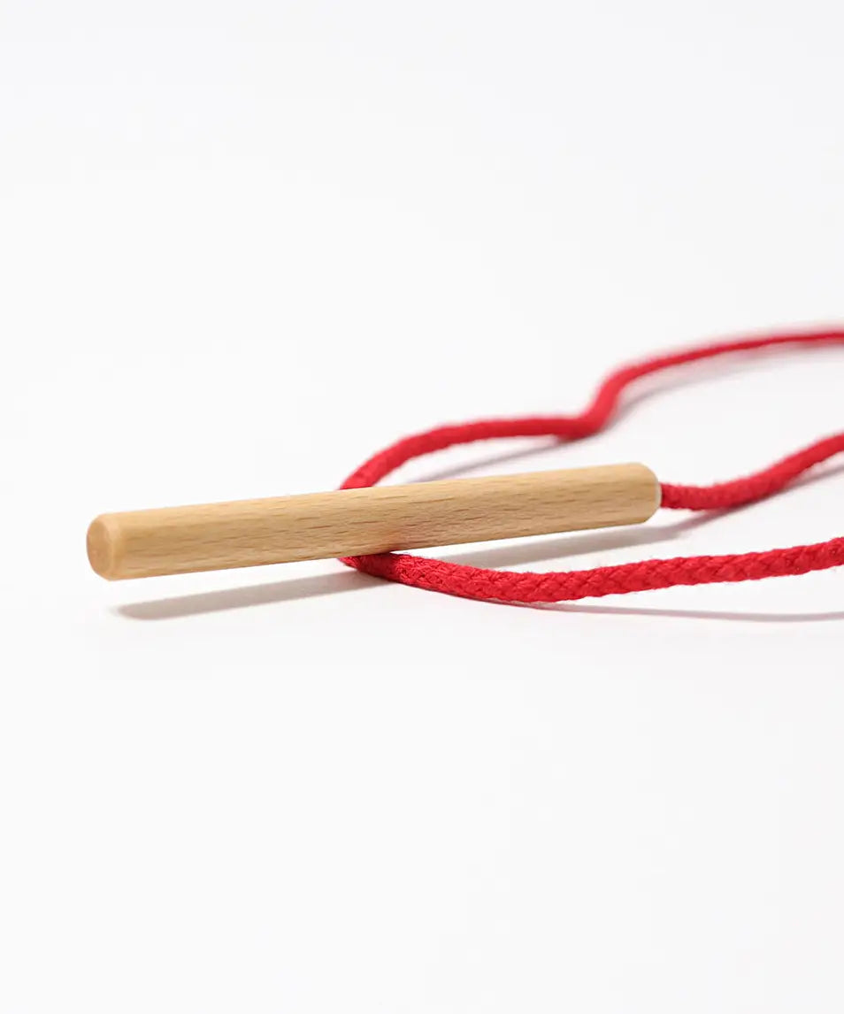 Grimms wooden threading needle showing needle detail with red cord attached