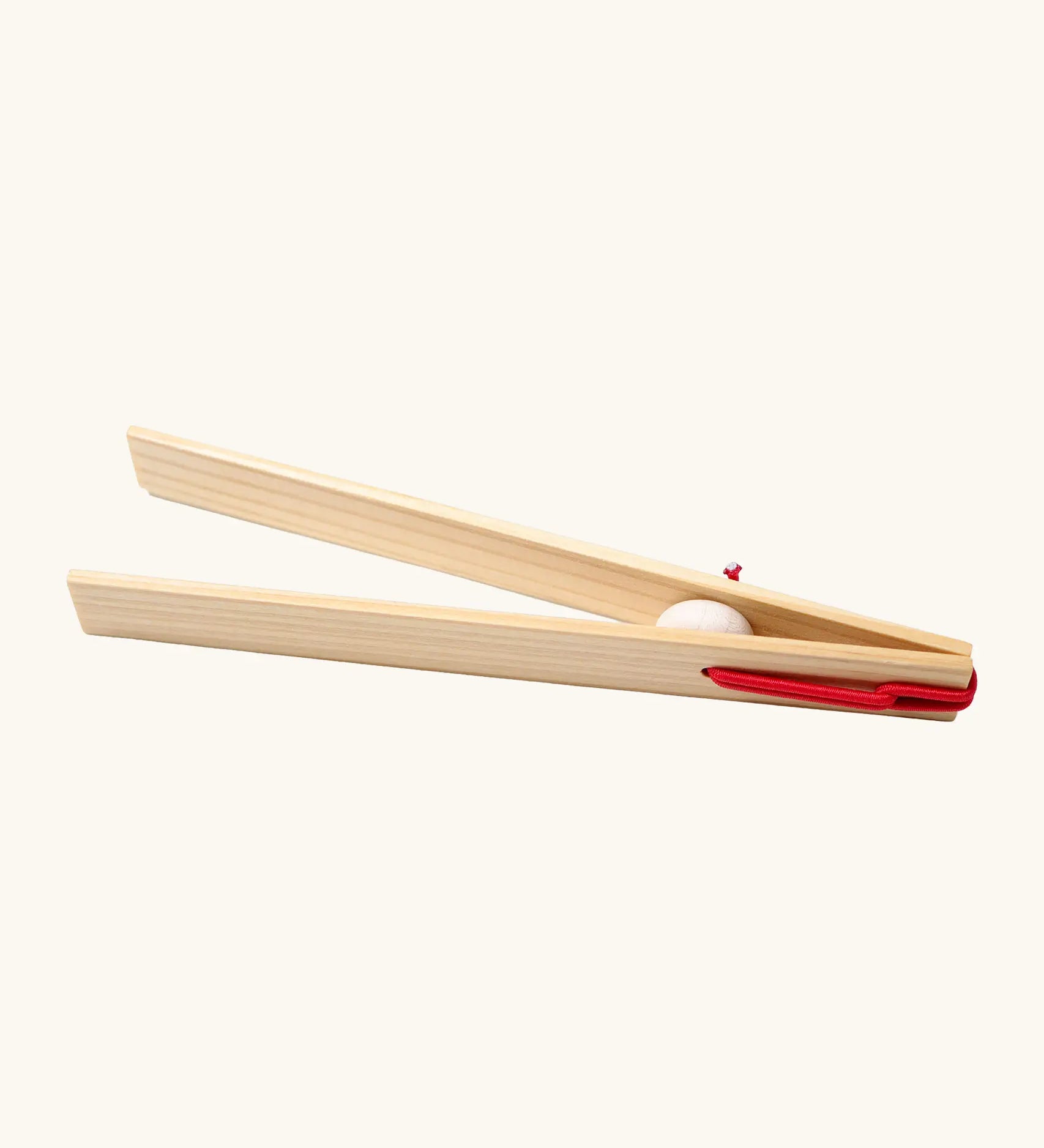 Grimms wooden 18cm tweezers held together by red elastic made to move small such as beads, marbles and small natural objects