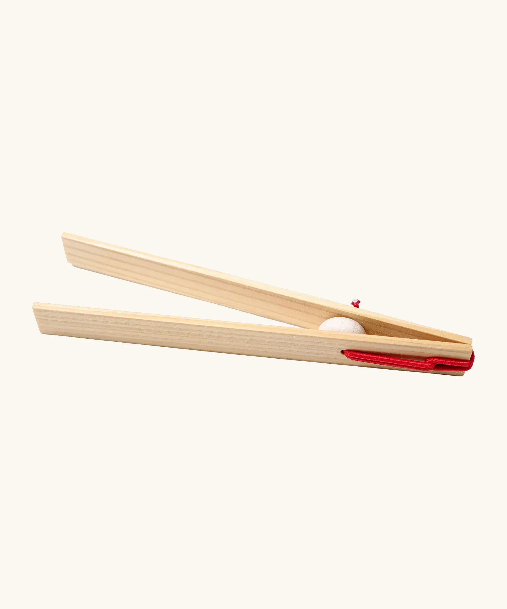 Grimms wooden 18cm tweezers held together by red elastic made to move small such as beads, marbles and small natural objects