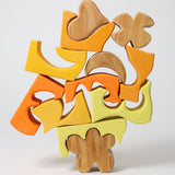 The yellow an natural wooden blocks from the Grimm's yellow building set stacked up on top of each other. These Grimm's toys are part of a wide range of wooden toys available here at Babipur. 