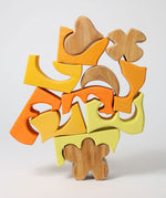 The yellow an natural wooden blocks from the Grimm's yellow building set stacked up on top of each other. These Grimm's toys are part of a wide range of wooden toys available here at Babipur. 