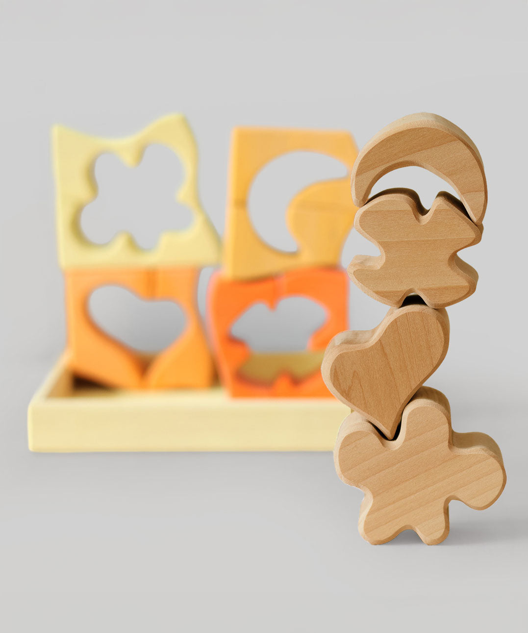 The natural wooden blocks from the Grimm's yellow building set stacked up on top of each other. The yellow an natural wooden blocks from the Grimm's yellow building set stacked up on top of each other. The rest of the pieces and yellow tray can be seen in the background. These Grimm's toys are part of a wide range of wooden toys available here at Babipur. 