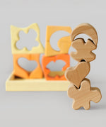The natural wooden blocks from the Grimm's yellow building set stacked up on top of each other. The yellow an natural wooden blocks from the Grimm's yellow building set stacked up on top of each other. The rest of the pieces and yellow tray can be seen in the background. These Grimm's toys are part of a wide range of wooden toys available here at Babipur. 