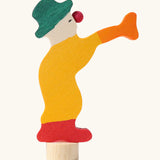 Grimm's yellow clown decorative figure for celebration rings, side profile view.