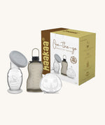 The Haakaa On-The-Go Express and Collect Breast Pump Travel Set. The set contains a Gen 2 Silicone Breast Pump, Ladybug Silicone Breast Milk Collector and a silicone milk storage bag. The set is pictured next to it's packaging box.