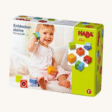 A cardboard box with a picture of a child playing with the blocks for the Haba blocks with sounds on a cream background.
