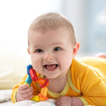 A baby happily chewing on the HABA Dilly Dally clutching and teething ring beads