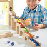 A child happily making music with the HABA Wooden Melodious Marble Run