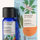 Harmony pure essential oil blend in a blue glass bottle in front of a decorative blue cardboard box.