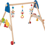 Heimess natural wooden baby gym and walker trainer on a beige background