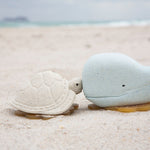 Hevea vanilla turtle and blue whale bath toys on the beach