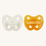 A two-pack of Hevea symmetrical teat baby pacifiers, made from 100% natural rubber and plastic-free. One in a milky white colour and one in a natural orange