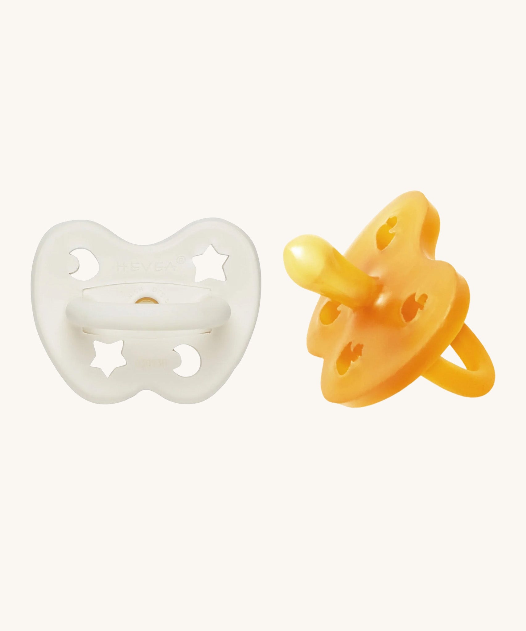 A two-pack of Hevea symmetrical teat baby pacifiers, made from 100% natural rubber and plastic-free. One in a milky white colour and one in a natural orange