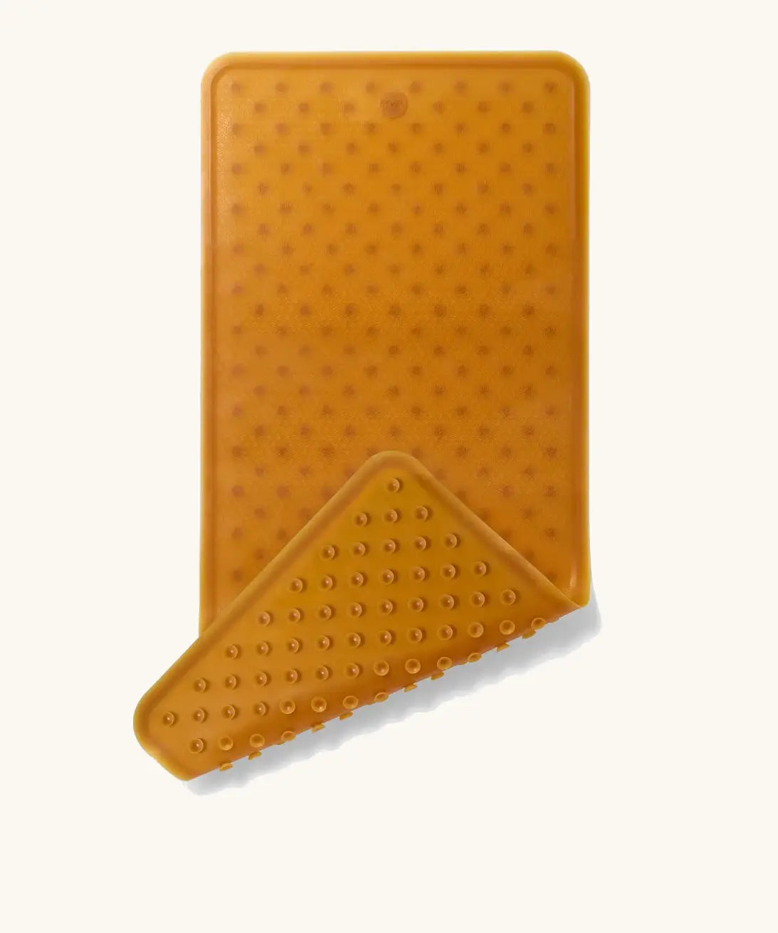 Hevea large natural rubber bath mat with corner flipped showing suction cups on the bottom, and a wave pattern on top for non-slip.