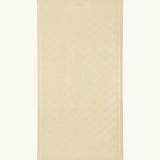 Hevea large natural rubber bath mat in Sand, a light beige, with wave pattern for non-slip.