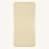 Hevea natural rubber bath mat in the sand colour on a beige background