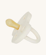 The Hevea natural rubber pacifier dummy with a symmetrical nipple shape, in milky white 